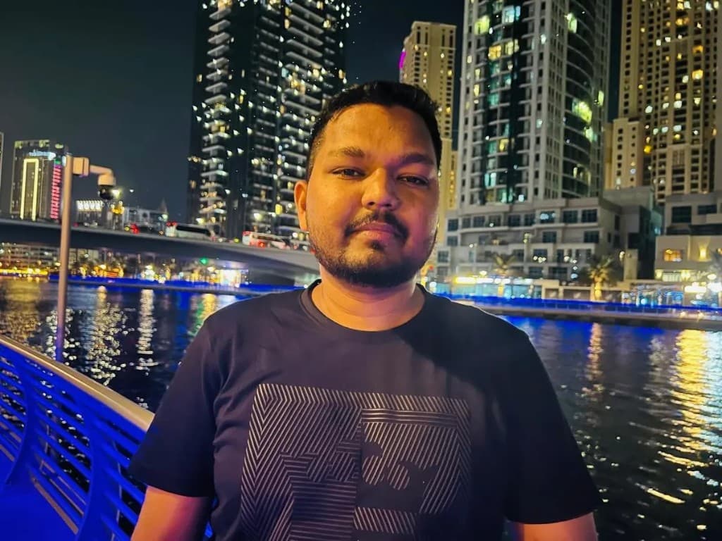 Tausif Ahmed, Founder and CEO of Bitronix Technologies, outdoors at night with a waterfront city skyline in the background.